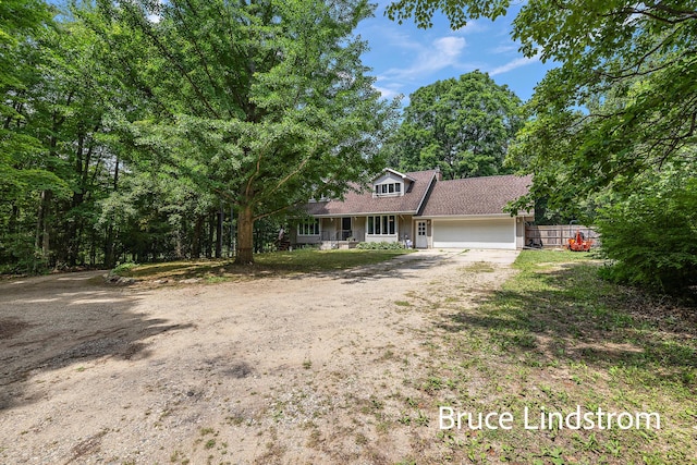 15520 157th Ave, Big Rapids, MI 49307 - view of front facade with a garage, driveway, and roof with shingles