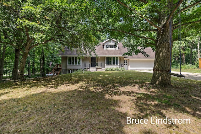 15520 157th Ave, Big Rapids, MI 49307 - view of front of home featuring covered porch, a garage, concrete driveway, and a front yard