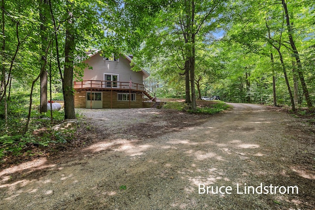 15520 157th Ave, Big Rapids, MI 49307 - back of house featuring a deck, stairway, and a wooded view