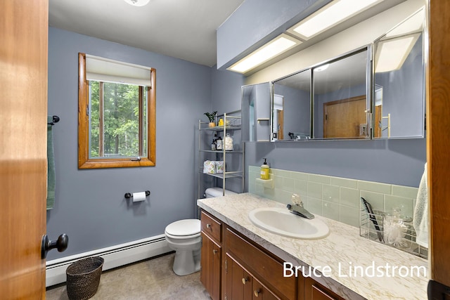 15520 157th Ave, Big Rapids, MI 49307 - bathroom with baseboard heating, backsplash, and vanity