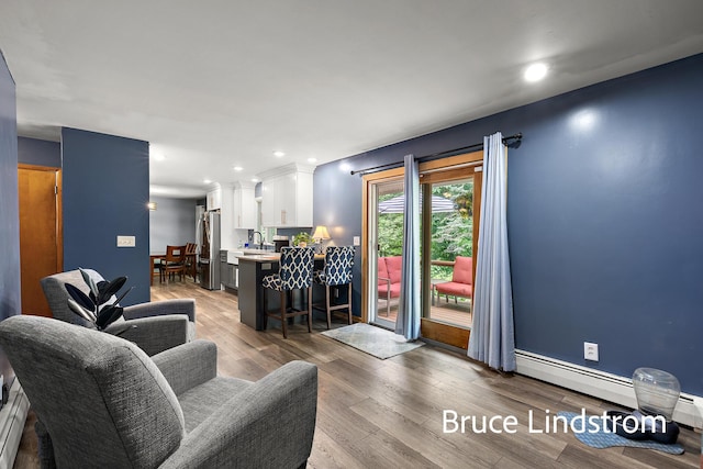 15520 157th Ave, Big Rapids, MI 49307 - living room featuring light wood finished floors, a baseboard radiator, and recessed lighting