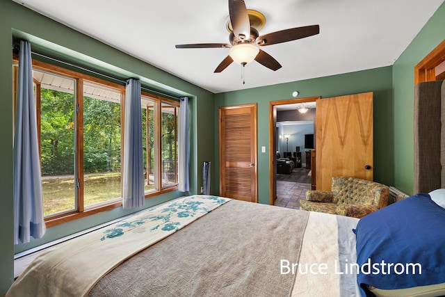 15520 157th Ave, Big Rapids, MI 49307 - bedroom featuring multiple windows, a ceiling fan, brick patterned floors, and a closet