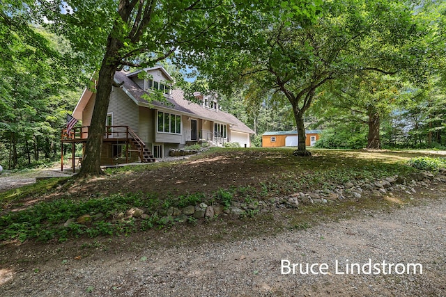 15520 157th Ave, Big Rapids, MI 49307 - view of front of home with a garage, stairway, and a wooden deck