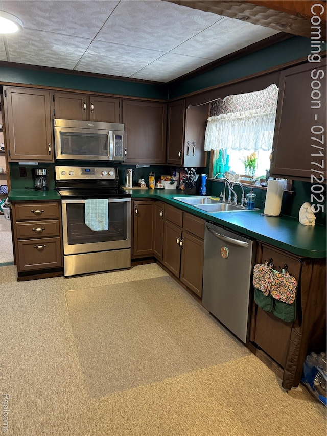 2185 Roslyn Ave, Flint, MI 48532 - kitchen featuring stainless steel appliances, dark countertops, and dark brown cabinetry