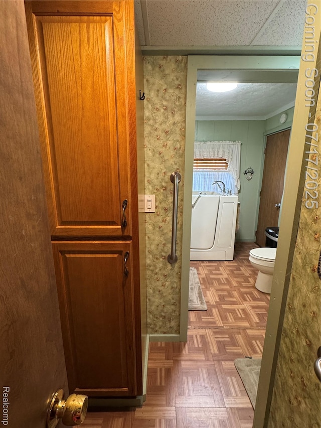 2185 Roslyn Ave, Flint, MI 48532 - bathroom featuring washer / dryer and ornamental molding