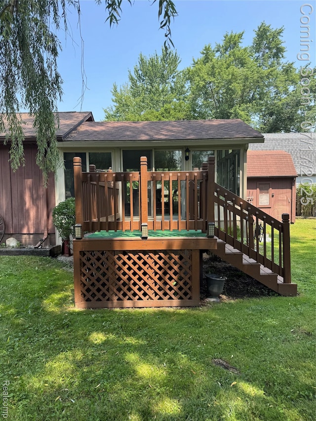2185 Roslyn Ave, Flint, MI 48532 - rear view of house featuring a deck, a yard, and roof with shingles
