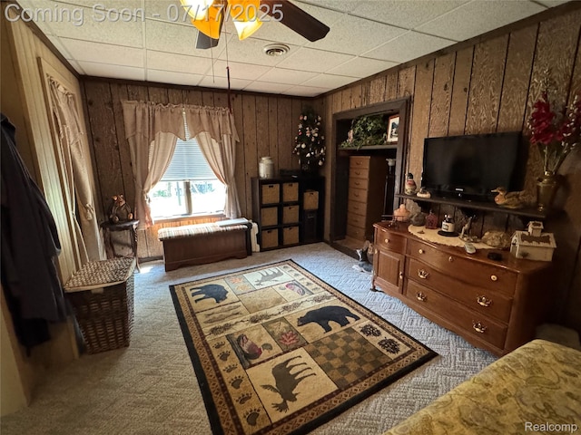 2185 Roslyn Ave, Flint, MI 48532 - living area featuring carpet, wooden walls, ceiling fan, and a drop ceiling