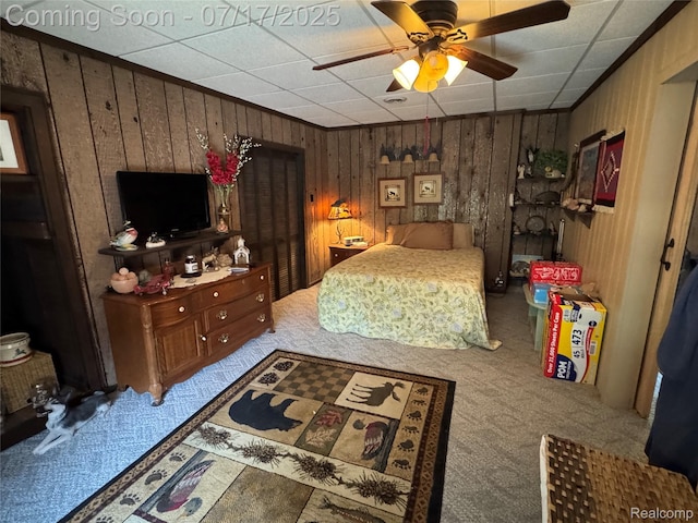 2185 Roslyn Ave, Flint, MI 48532 - carpeted bedroom with wood walls and a ceiling fan