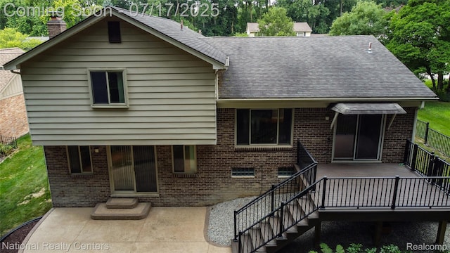 625 Ten Point Dr, Rochester Hills, MI 48309 - back of property with brick siding, a patio area, a chimney, and a shingled roof