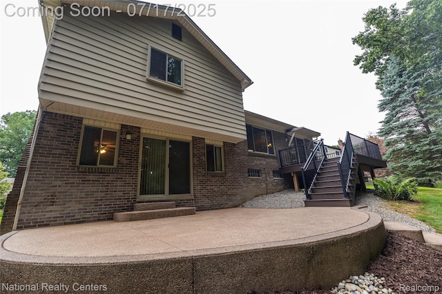 625 Ten Point Dr, Rochester Hills, MI 48309 - rear view of property featuring brick siding, stairs, a deck, and a patio area