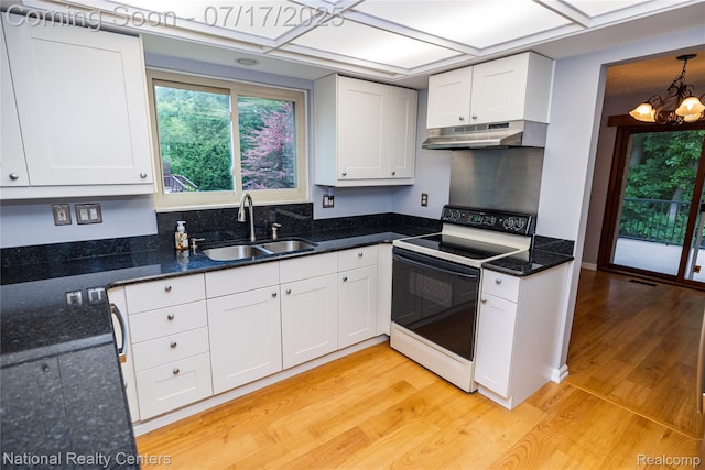 625 Ten Point Dr, Rochester Hills, MI 48309 - kitchen with electric stove, under cabinet range hood, light wood-style flooring, white cabinetry, and a chandelier