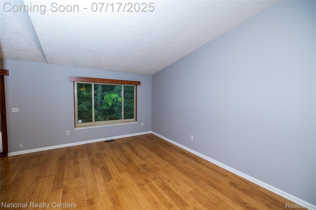 625 Ten Point Dr, Rochester Hills, MI 48309 - spare room featuring wood finished floors, a textured ceiling, and lofted ceiling