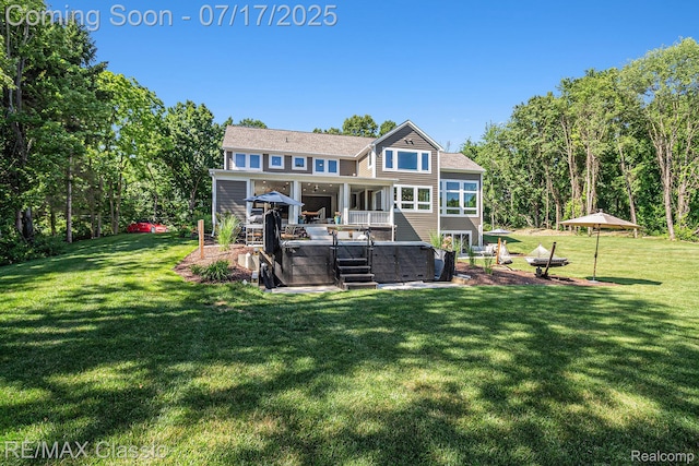 7171 Lucy Dr, Dexter, MI 48130 - back of property with a hot tub, a lawn, and a patio