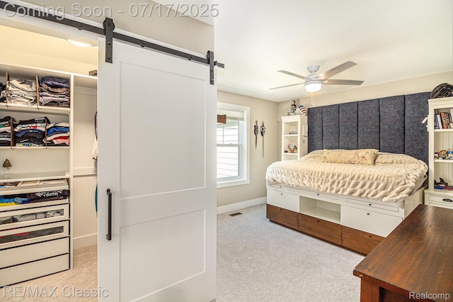 7171 Lucy Dr, Dexter, MI 48130 - bedroom featuring a barn door, light carpet, and ceiling fan