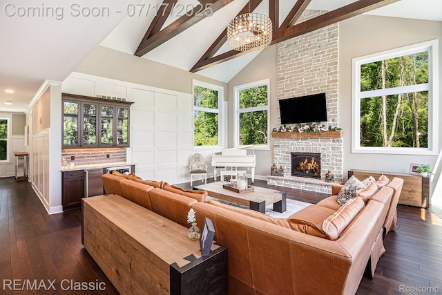 7171 Lucy Dr, Dexter, MI 48130 - living room with dark wood-type flooring, plenty of natural light, beam ceiling, a brick fireplace, and high vaulted ceiling