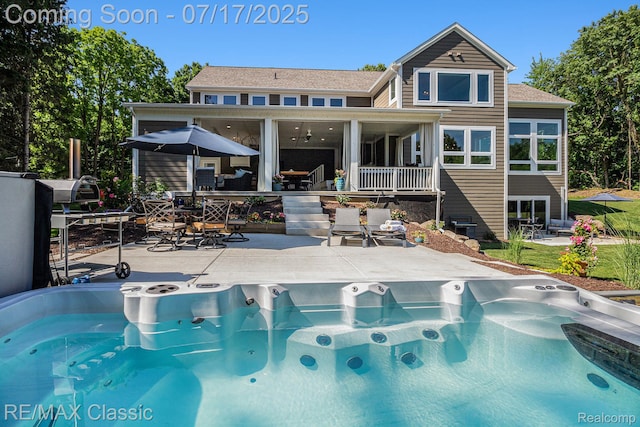 7171 Lucy Dr, Dexter, MI 48130 - back of property featuring a hot tub, outdoor dining space, and a patio