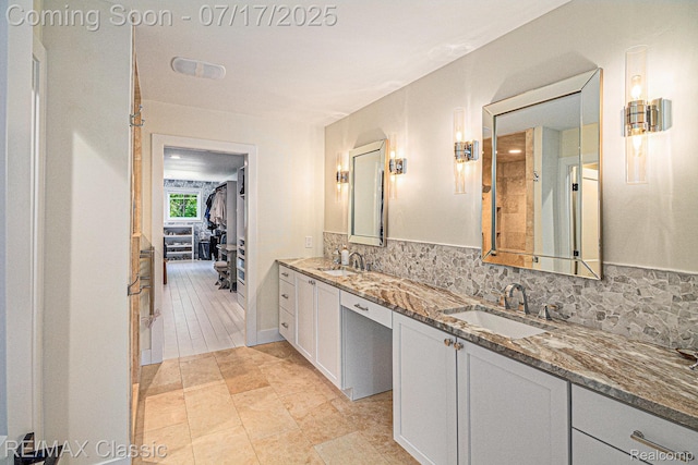 7171 Lucy Dr, Dexter, MI 48130 - bathroom with tasteful backsplash, double vanity, and a walk in closet