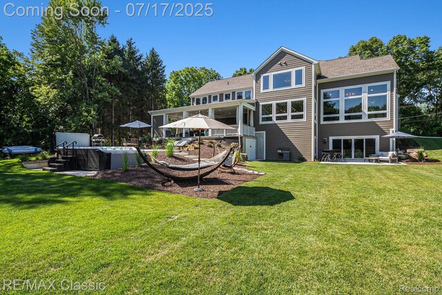 7171 Lucy Dr, Dexter, MI 48130 - rear view of house featuring a yard, a jacuzzi, and a patio
