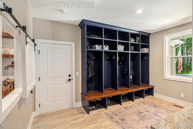 7171 Lucy Dr, Dexter, MI 48130 - mudroom with a barn door and recessed lighting