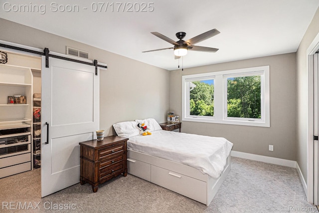 7171 Lucy Dr, Dexter, MI 48130 - bedroom with light colored carpet, a barn door, and a ceiling fan