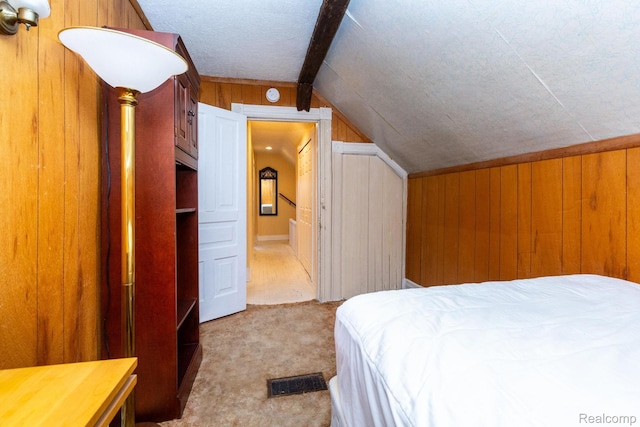 19817 Martin Rd, Saint Clair Shores, MI 48081 - bedroom featuring wood walls, vaulted ceiling, carpet, and ensuite bath