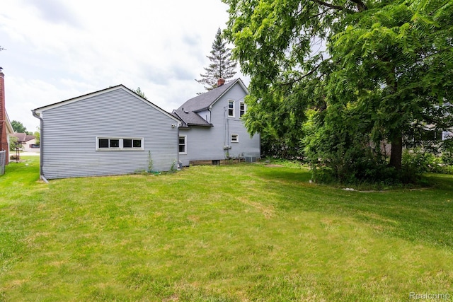 19817 Martin Rd, Saint Clair Shores, MI 48081 - back of house featuring a chimney and a lawn
