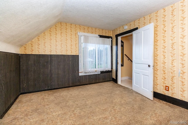 19817 Martin Rd, Saint Clair Shores, MI 48081 - additional living space with wallpapered walls, a textured ceiling, carpet floors, and lofted ceiling
