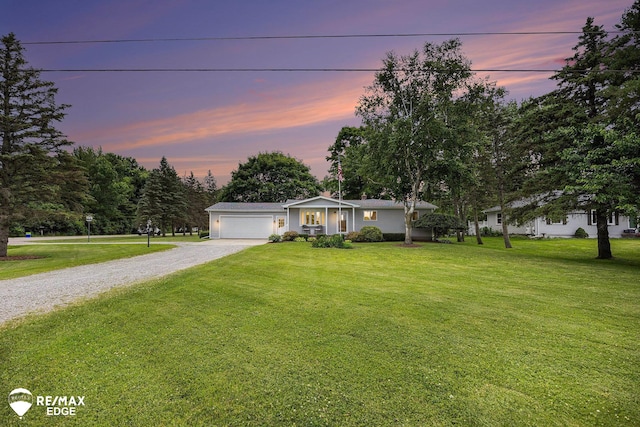8208 E Potter Rd, Davison, MI 48423 - ranch-style home featuring gravel driveway, a garage, a front lawn, and view of scattered trees