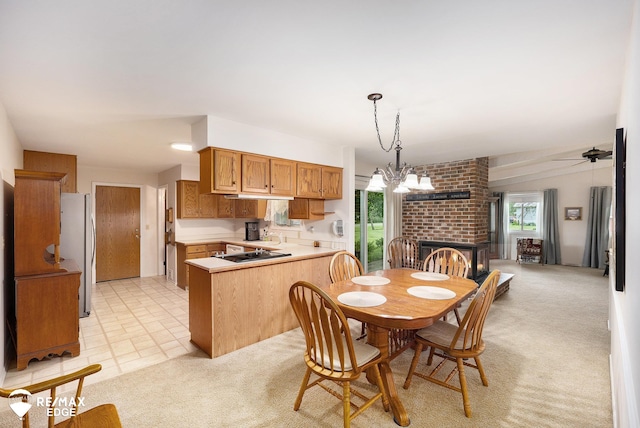 8208 E Potter Rd, Davison, MI 48423 - dining room with a fireplace, light carpet, ceiling fan, and a chandelier