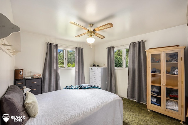 8208 E Potter Rd, Davison, MI 48423 - bedroom with multiple windows, dark carpet, and a ceiling fan