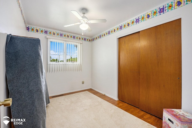 8208 E Potter Rd, Davison, MI 48423 - unfurnished bedroom featuring wood finished floors, a closet, and ceiling fan