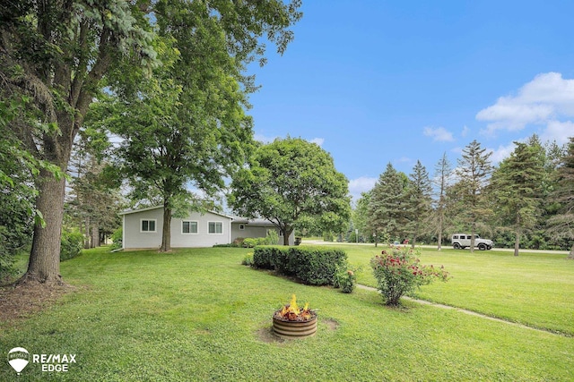 8208 E Potter Rd, Davison, MI 48423 - view of grassy yard featuring a fire pit