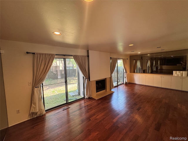 5216 Brett Ct, West Bloomfield, MI 48322 - unfurnished living room featuring dark wood finished floors, a fireplace with raised hearth, and recessed lighting
