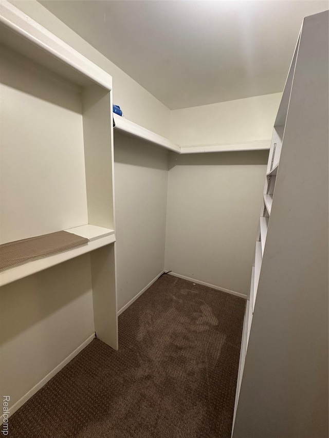5216 Brett Ct, West Bloomfield, MI 48322 - walk in closet featuring dark carpet