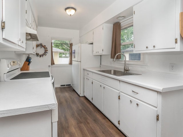 3130 27th St SW, Grandville, MI 49418 - kitchen with white appliances, under cabinet range hood, light countertops, and white cabinetry