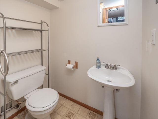 3130 27th St SW, Grandville, MI 49418 - bathroom featuring toilet and tile patterned floors