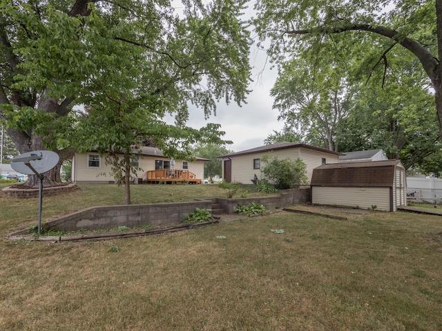 3130 27th St SW, Grandville, MI 49418 - view of grassy yard with a storage shed and a deck