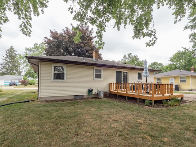 3130 27th St SW, Grandville, MI 49418 - back of property with a wooden deck, a yard, and a chimney