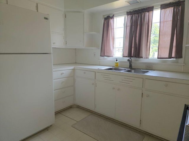 1115 W Maumee St, Adrian, MI 49221 - kitchen featuring freestanding refrigerator, light countertops, open shelves, and white cabinetry
