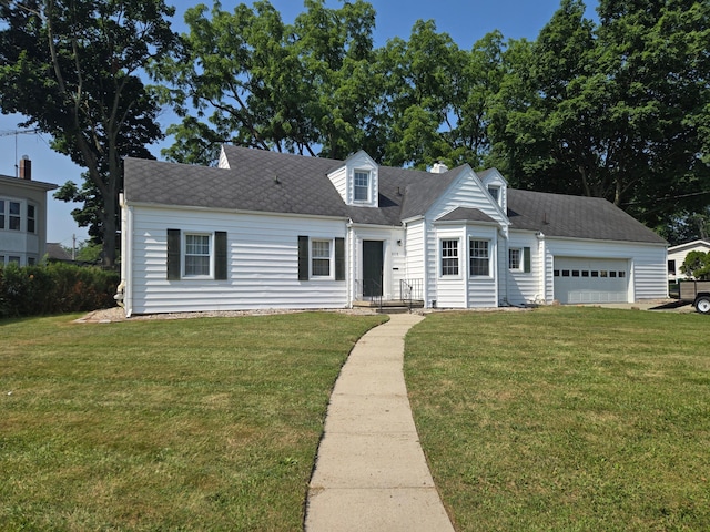 1115 W Maumee St, Adrian, MI 49221 - cape cod house with a front yard, a garage, and roof with shingles