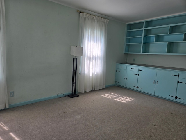 1115 W Maumee St, Adrian, MI 49221 - unfurnished living room with light carpet and baseboards