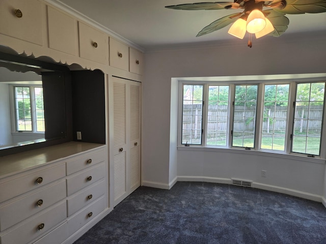 1115 W Maumee St, Adrian, MI 49221 - unfurnished bedroom featuring dark carpet, a closet, crown molding, and ceiling fan