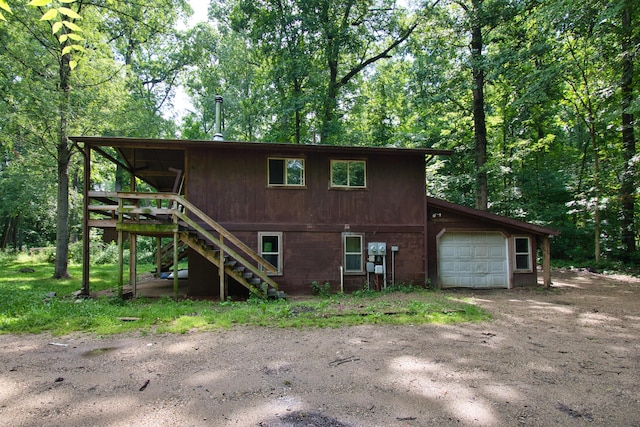 23627 Glenwood Rd, Cassopolis, MI 49031 - back of property with stairs, dirt driveway, and a wooden deck