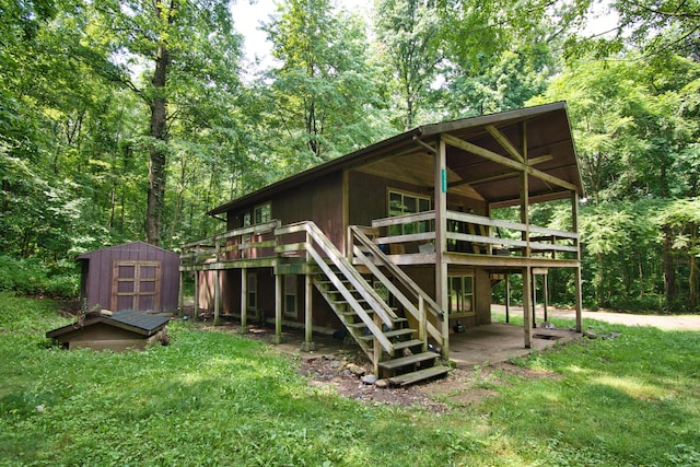23627 Glenwood Rd, Cassopolis, MI 49031 - rear view of property with a storage unit, stairway, a deck, a yard, and a forest view