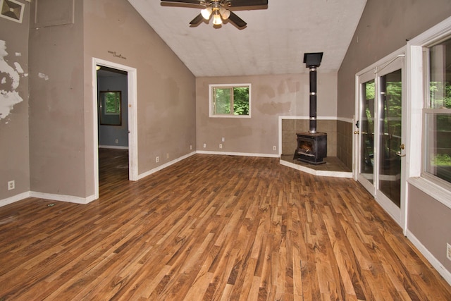 23627 Glenwood Rd, Cassopolis, MI 49031 - unfurnished living room with a wood stove, wood finished floors, lofted ceiling, and ceiling fan