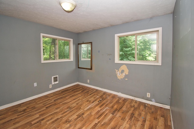 23627 Glenwood Rd, Cassopolis, MI 49031 - spare room featuring healthy amount of natural light, wood finished floors, and a textured ceiling