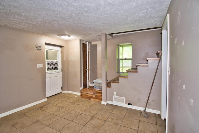 23627 Glenwood Rd, Cassopolis, MI 49031 - entryway featuring stairs, tile patterned floors, and a textured ceiling