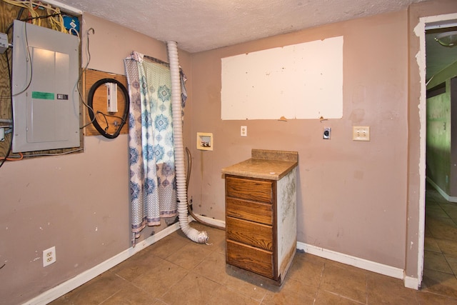 23627 Glenwood Rd, Cassopolis, MI 49031 - bathroom with electric panel, tile patterned flooring, and a textured ceiling