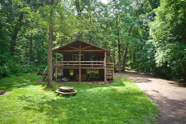 23627 Glenwood Rd, Cassopolis, MI 49031 - view of front of property featuring stairs, a deck, a forest view, a front lawn, and driveway