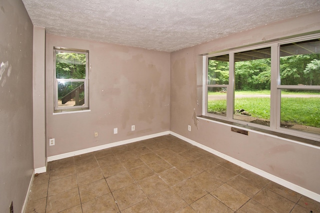 23627 Glenwood Rd, Cassopolis, MI 49031 - unfurnished room featuring plenty of natural light, a textured ceiling, and tile patterned flooring